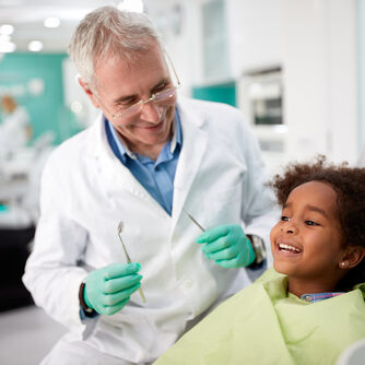 Happy dentist, happy child, dental office, dental chair